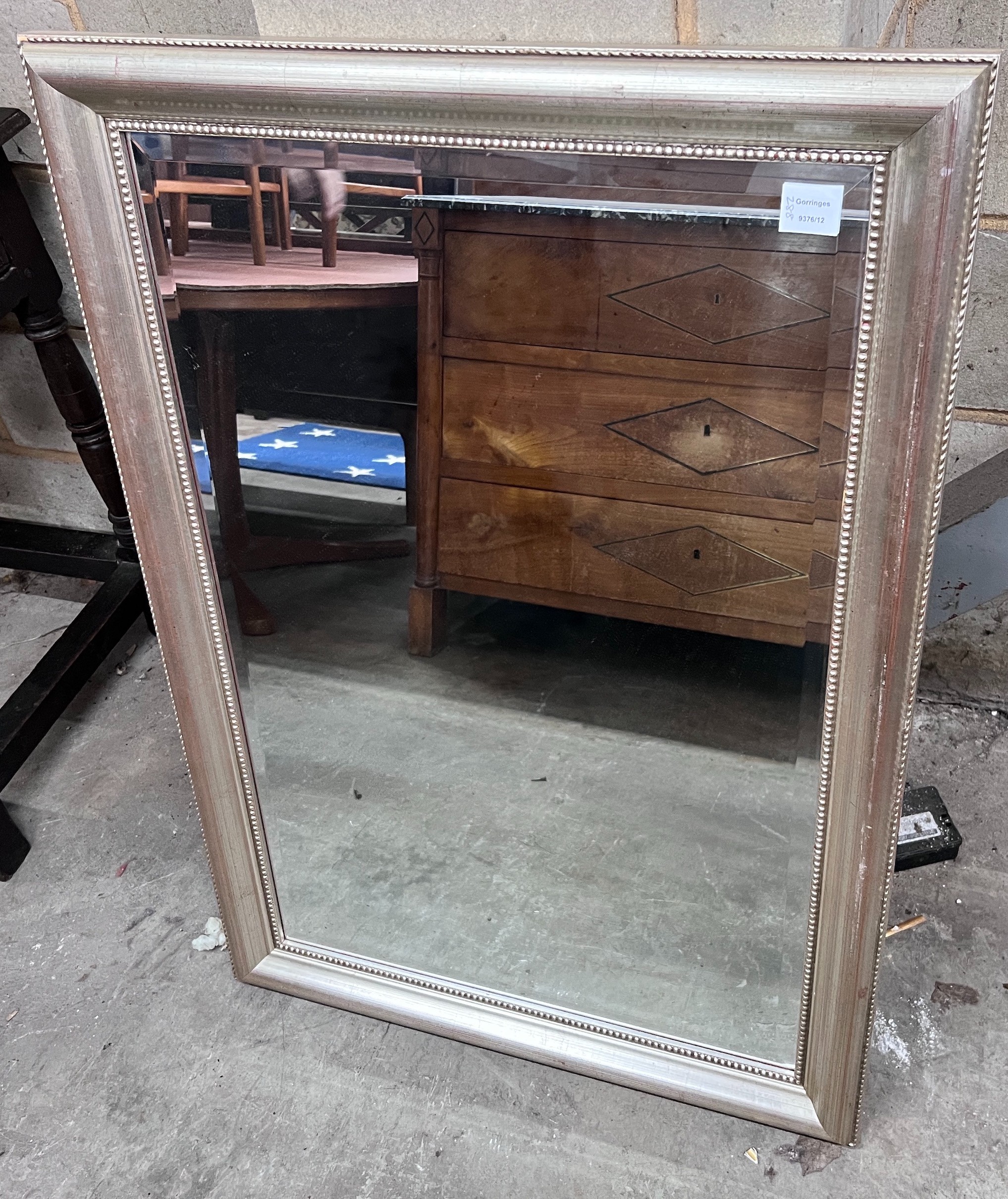 A silvered wood framed wall mirror, width 74cm, height 105cm *Please note the sale commences at 9am.
